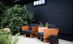 Black outdoor stump table on a patio with outdoor chairs