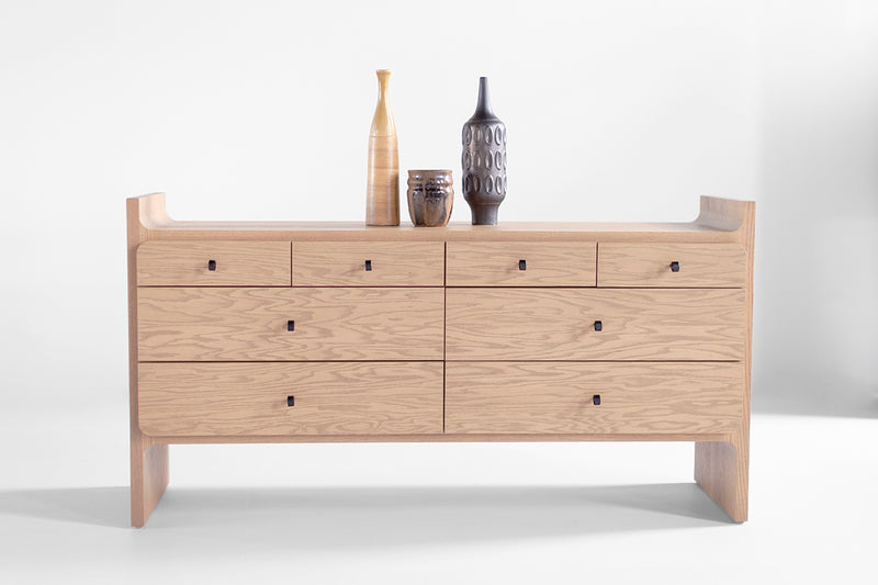 Side profile of the Parker dresser in weathered oak, showing its tapered wood panel design
