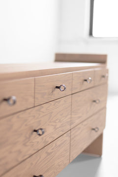 Modern luxury Parker weathered oak dresser in a sunlit room, styled as a bedroom statement piece