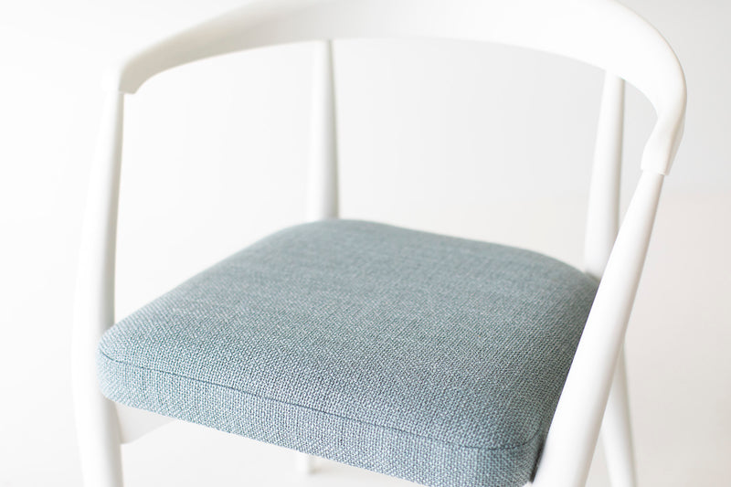 White lacquer finish on the maple frame of the Peabody modern dining armchair