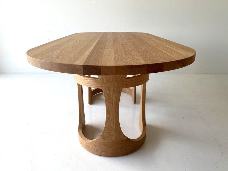 Modern luxury oak dining table by Craft Associates®, long Barricas design shown in a bright dining space