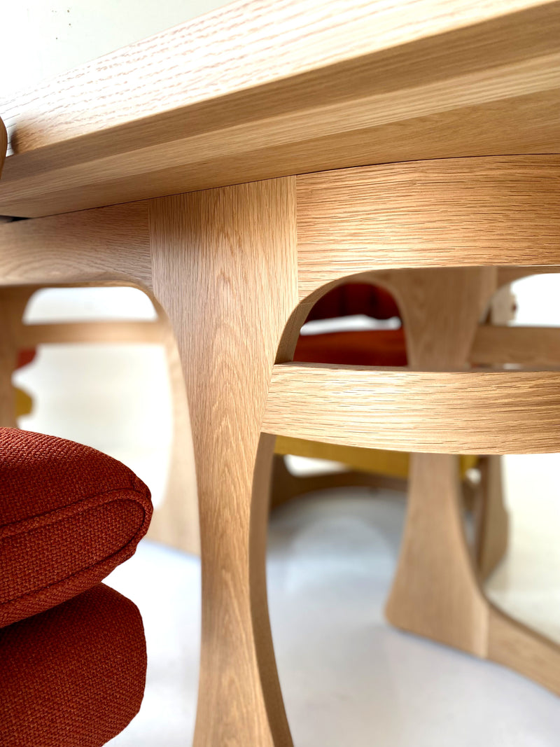 Angled view of the modern luxury Barricas oak dining table by Craft Associates® showing its solid-wood base and matte finish