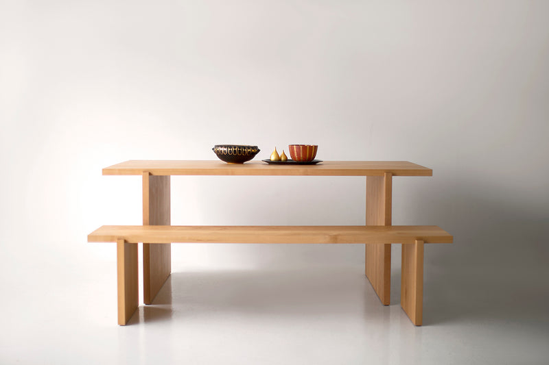 Side angle of a clear alder dining table highlighting the inset tabletop