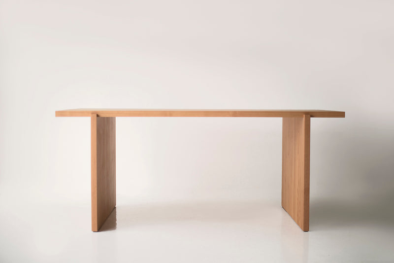 Close-up of the wood grain and matte finish on a Rockefeller dining table