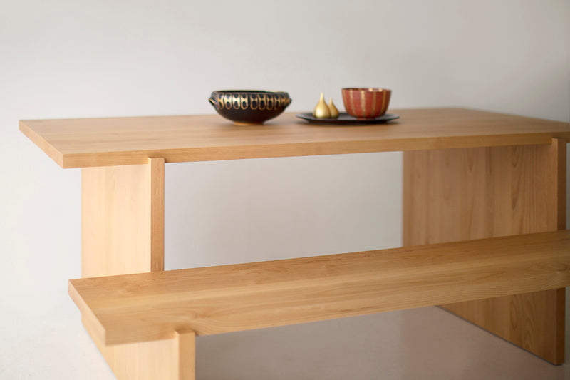 Overhead view of a natural wood dining table showing the tabletop surface
