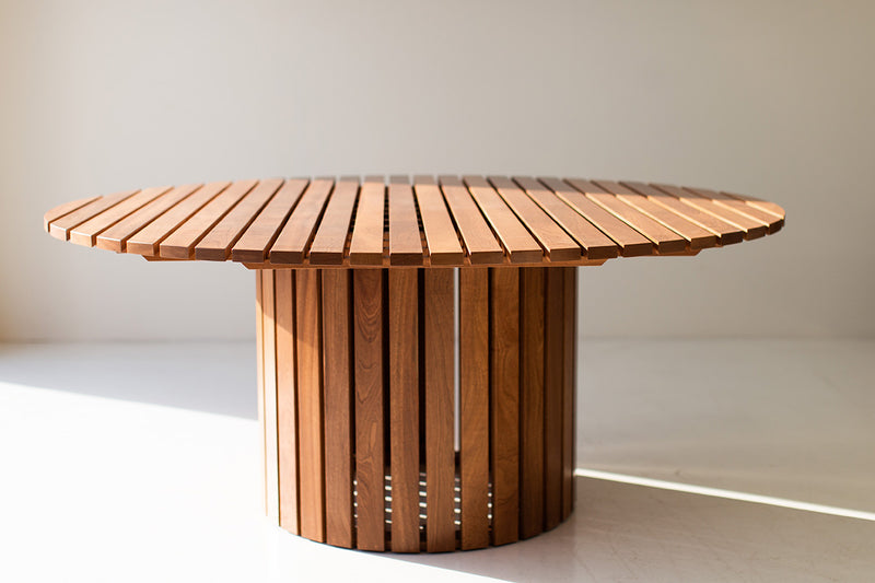 Round outdoor wood dining table The Hamptons in natural mahogany, front view