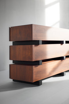 Close-up of walnut wood grain and blackened beam offset on a modern luxury dresser