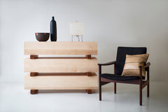 Modern maple dresser styled with decor on top in a bedroom setting