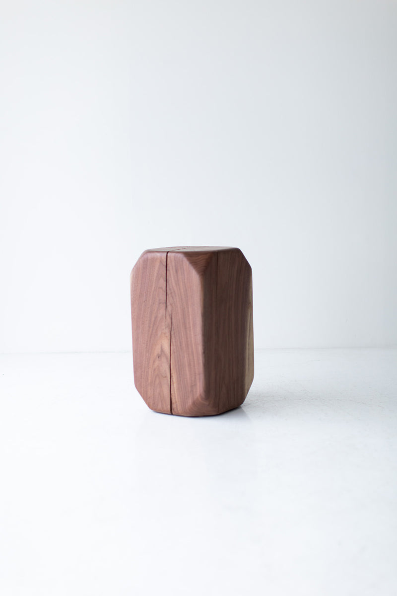 Modern walnut side table placed beside a sofa