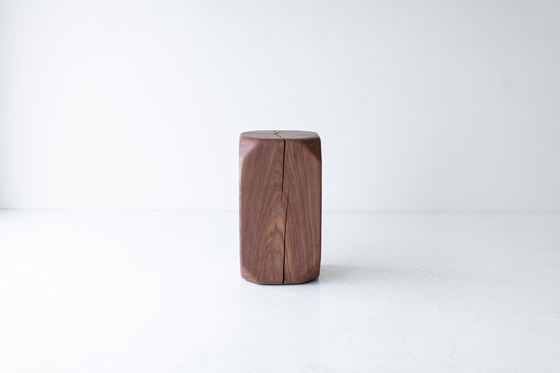 Organic modern walnut side table in a bright room