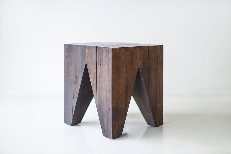 Front view of a Vega stump table showing its sculpted maple shape