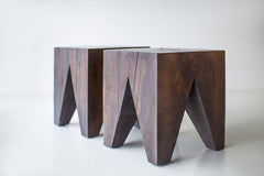 Side profile of a solid wood side table highlighting its organic silhouette