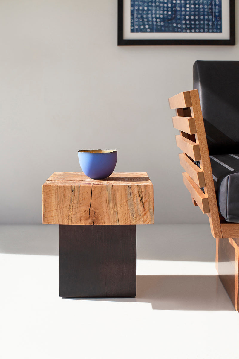 Front view of a Viktor side table showing its rough cut maple texture