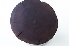 Close-up of the natural walnut grain and bark edge on the stump table