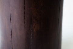 Side profile of the solid walnut stump table showing its tall, organic form