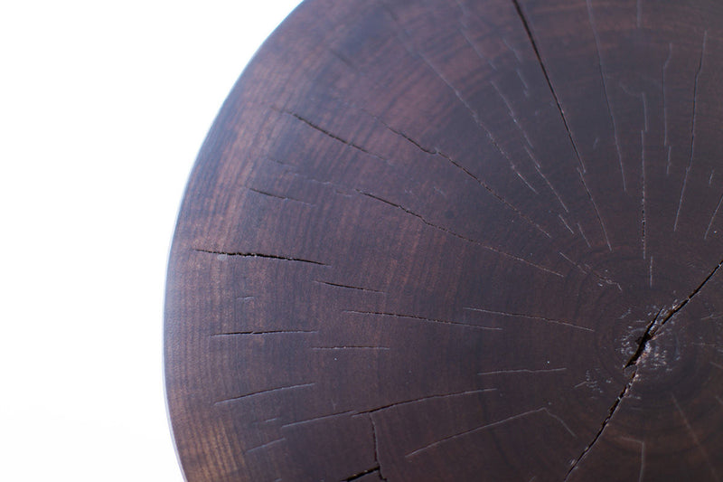 Angled view of the solid walnut stump table displaying its organic character
