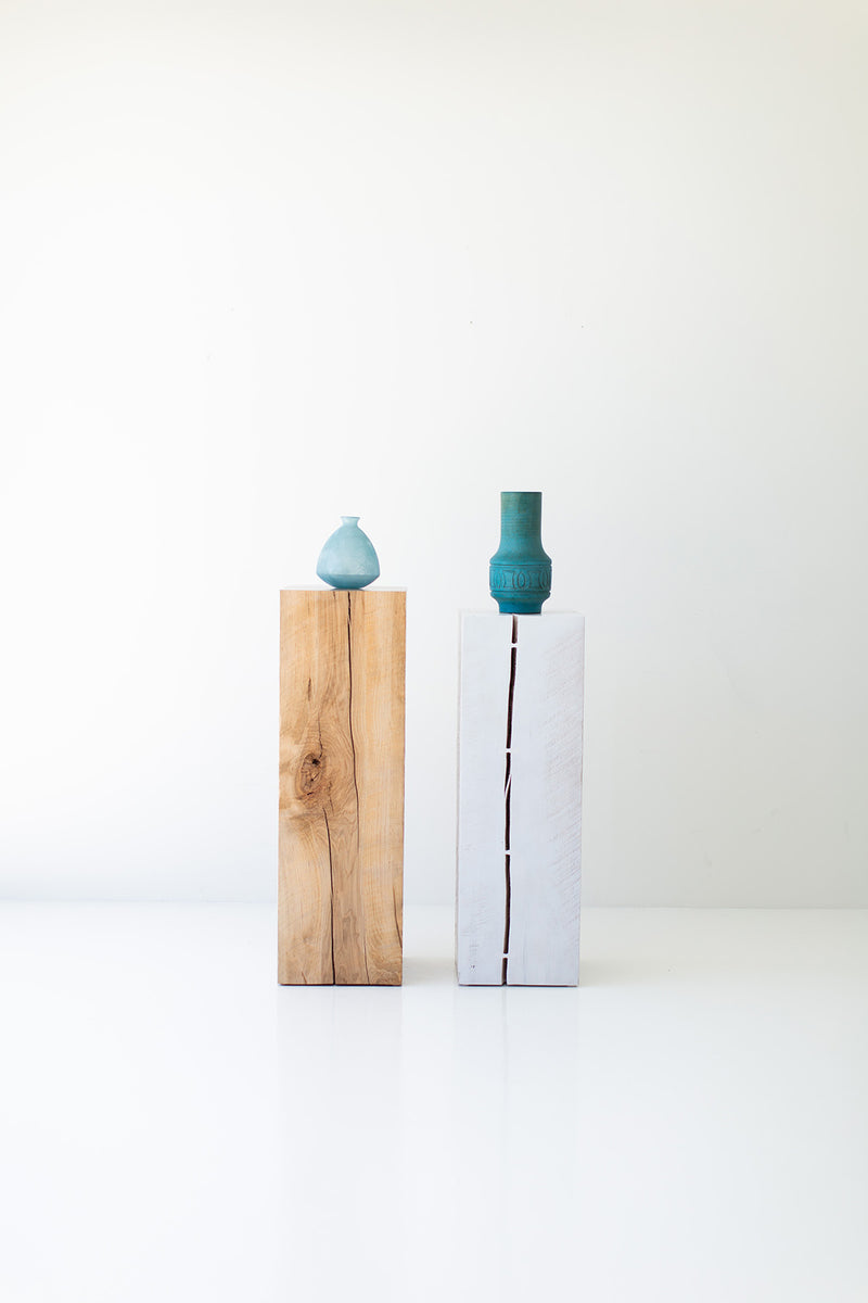 Natural and whitewash maple art pedestals side by side