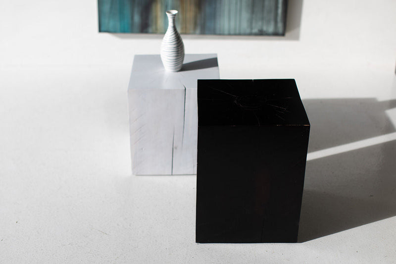 Whitewash and black maple block end tables with a vase