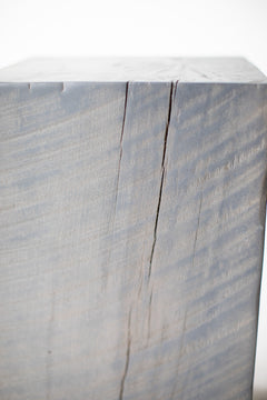 Slate grey stump table styled in a bright interior