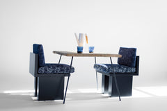 Side profile of an outdoor dining chair highlighting its straight back