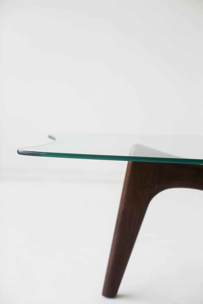 Close-up of the hand-shaped walnut legs on the Surf coffee table