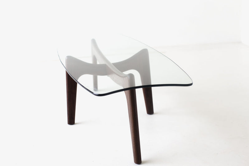 Angled view of the Surf walnut coffee table with glass top