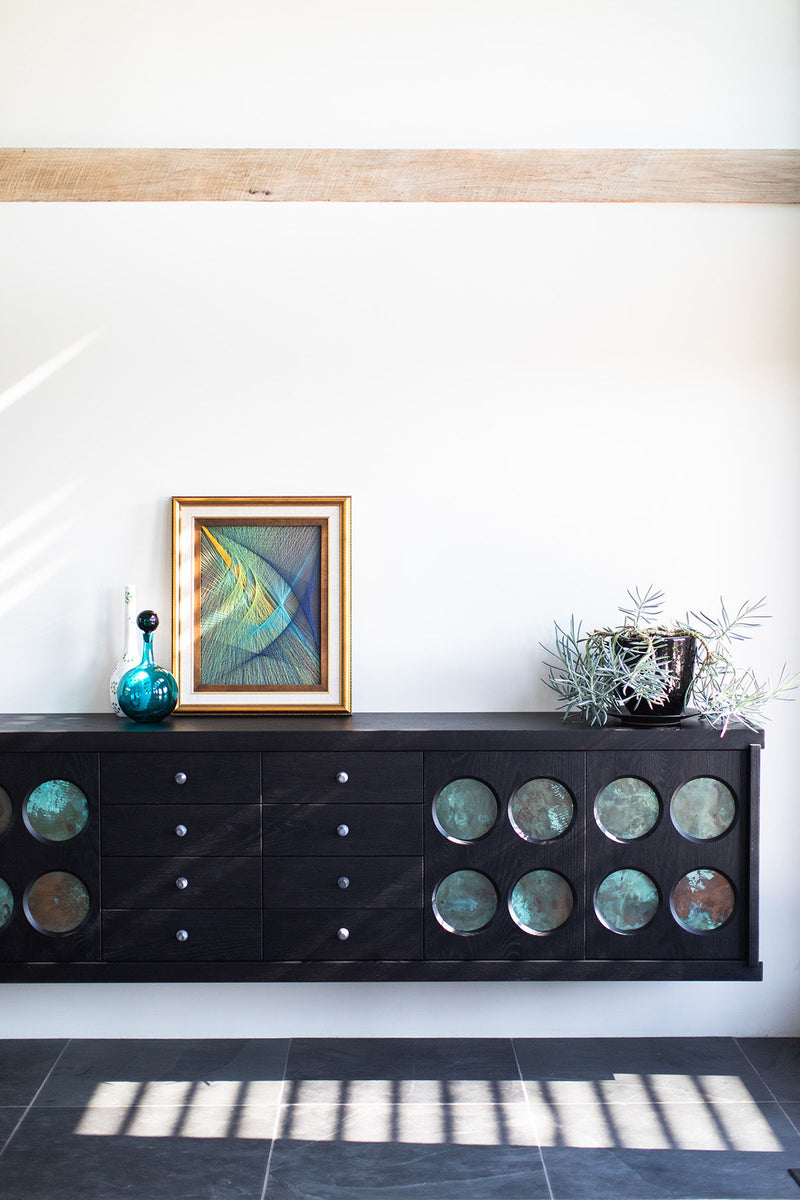 Modern luxury Toussaint credenza styled with decor and artwork above it