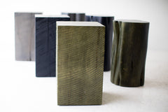 Bertu Home army green stump table shown at an angle