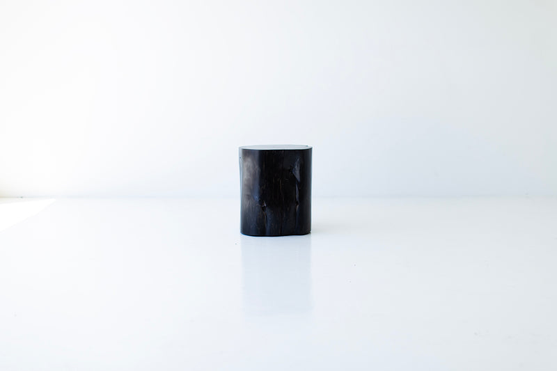 Tree stump table styled as a side table next to an armchair