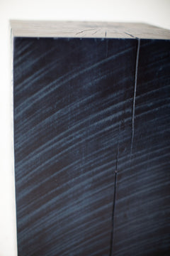 Denim blue stump table styled in a bright interior