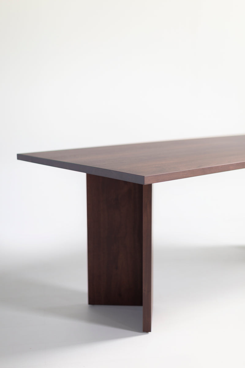 Close-up of the joinery and craftsmanship on the Triad walnut table legs