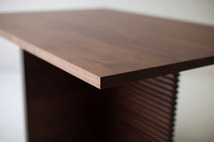 Detail shot of the walnut grain on the Cicely dining table's surface