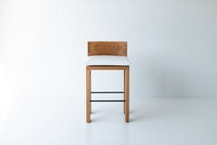 Full view of the counter stool against a plain backdrop