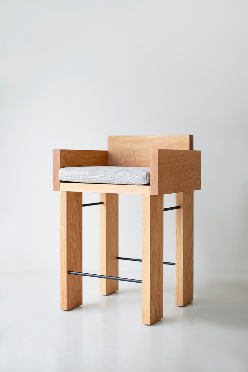 Pair of white oak counter stools with arms side by side