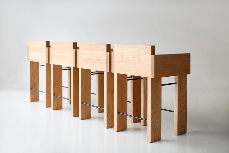 Side profile of the stool showing the black metal rod frame