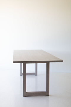 Modern whitewash oak dining table styled as a luxury desk