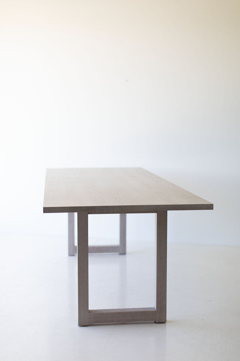 Modern whitewash oak dining table styled as a luxury desk