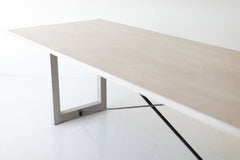 Modern luxury whitewash dining table styled in a bright dining room
