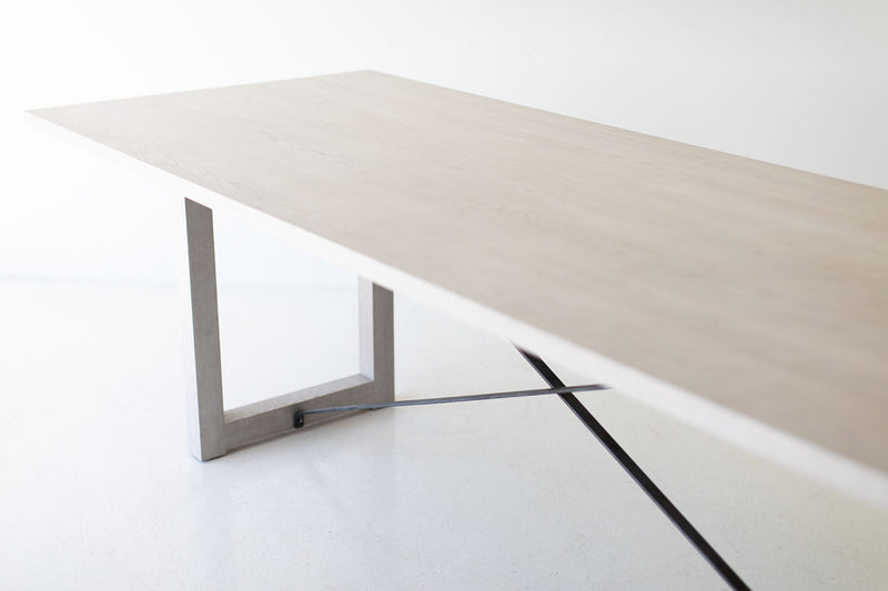Modern luxury whitewash dining table styled in a bright dining room