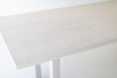 Close-up of the commercial-grade whitewash finish on the modern oak table