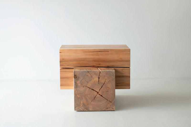 Side profile of a wood beam end table highlighting its geometric silhouette
