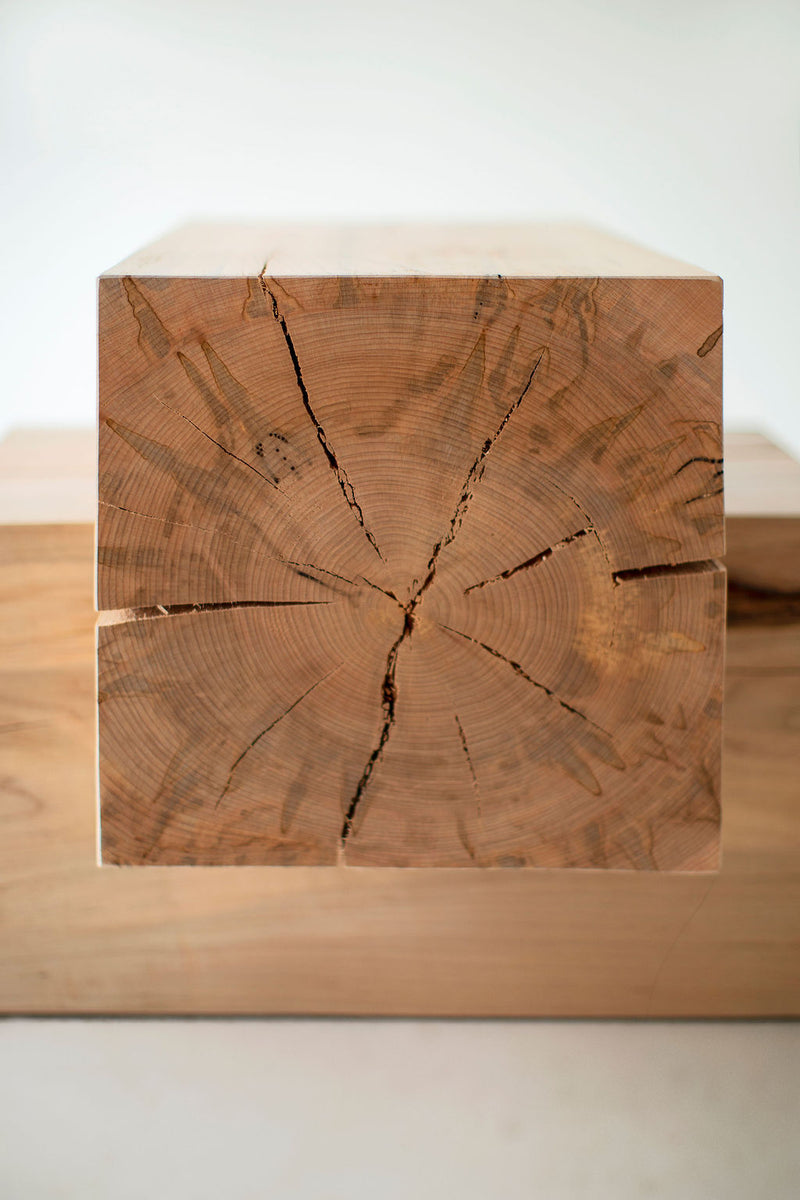 Wood beam end table styled beside a sofa in a living room