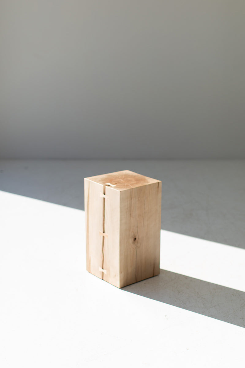 Overhead view of the wood side table's round top showing natural grain