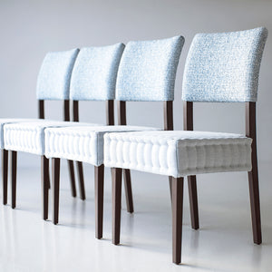 may include: modern quilted siding chairs that are hand stitched, wood is oak, style luxury and modern and sleek, chairs sit on white floors, background is white, chairs for luxury kitchens, image 01