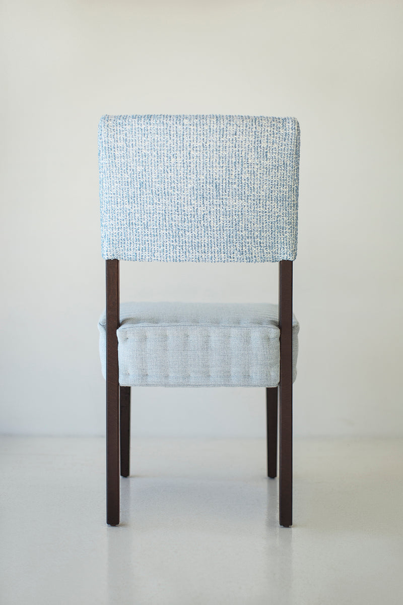 Detail of the leather grain and hand-stitched panels on a quilted chair