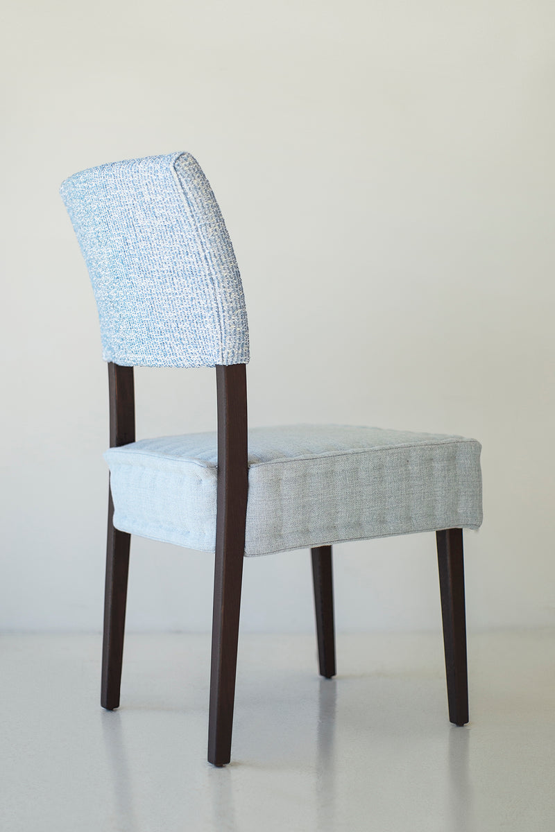 Quilted dining chairs styled around a table in a modern kitchen