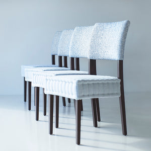 may include: modern quilted siding chairs that are hand stitched, wood is oak, style luxury and modern and sleek, chairs sit on white floors, background is white, chairs for luxury kitchens, image 09