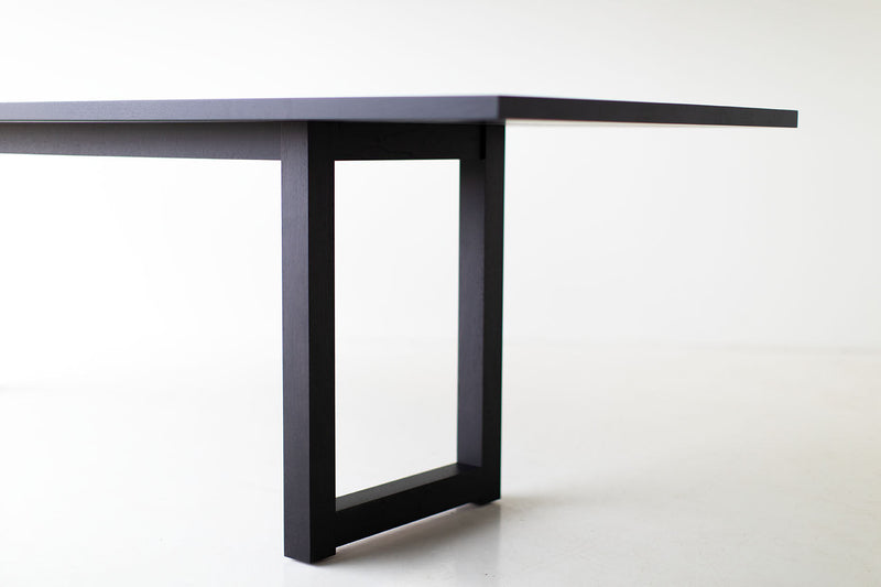 Modern luxury solid black walnut dining table by Bertu Home shown at an angle