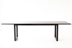 Close-up of the solid black walnut grain on the modern dining table