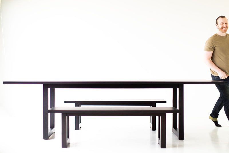 Modern luxury black walnut dining table styled with place settings